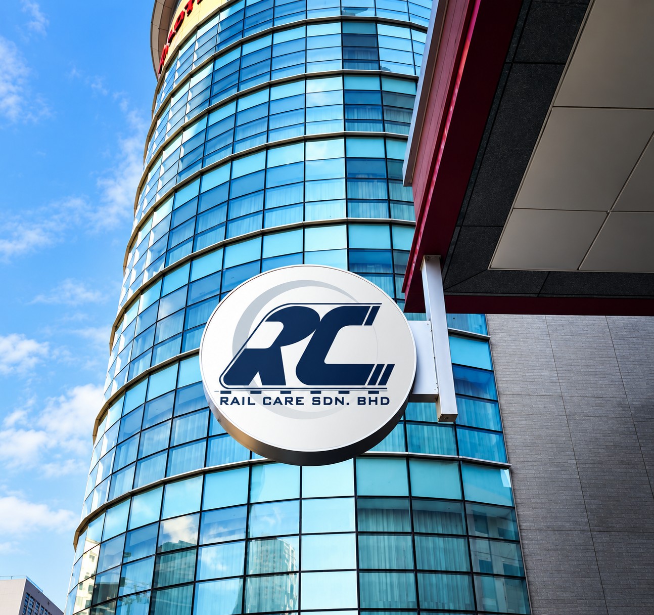 Rail Care round logo sign mocked up on a glass office tower